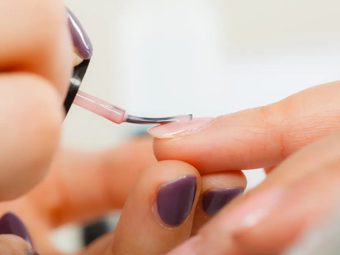 A nail technician working on a manicure.